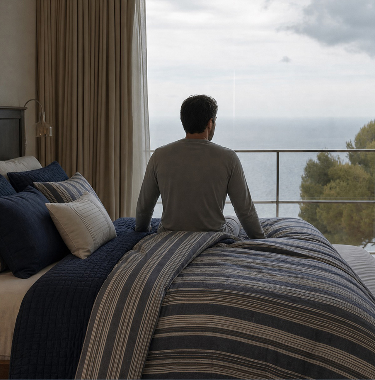 A bedroom made up with Northport Loop bedding, overlooking the sea